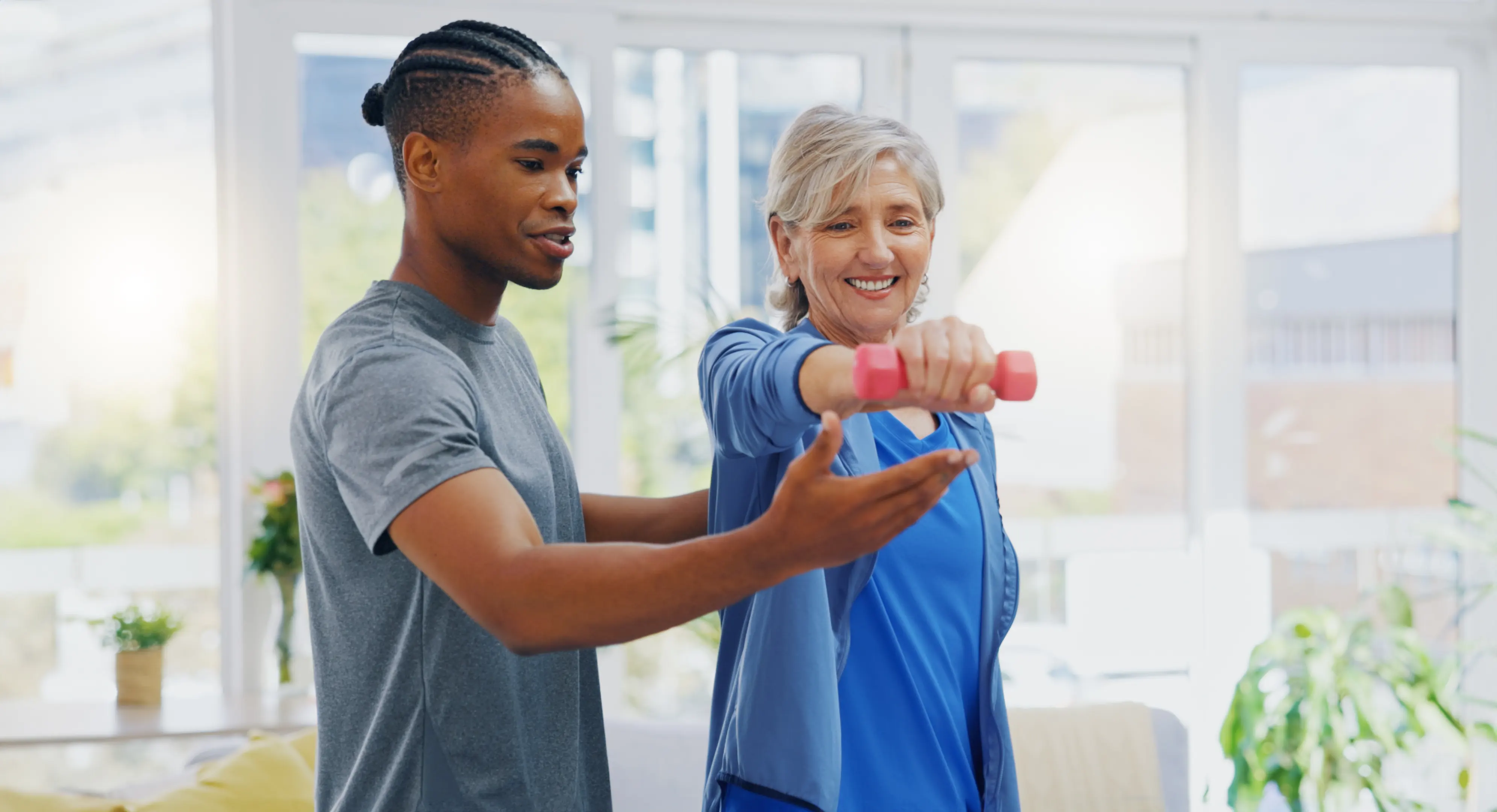 therapist working with a women using a hand weight