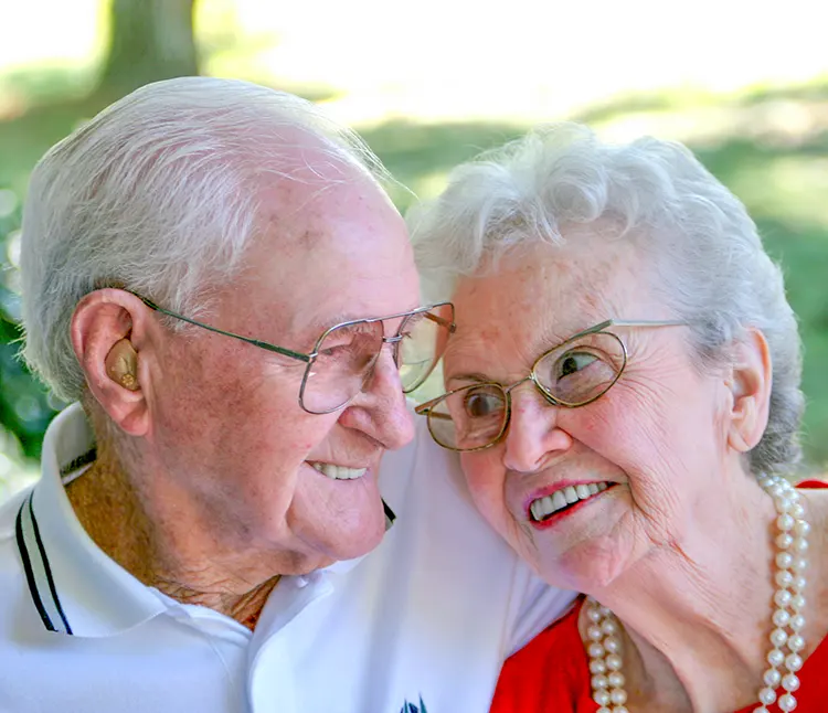 elderly couple smiling at each other