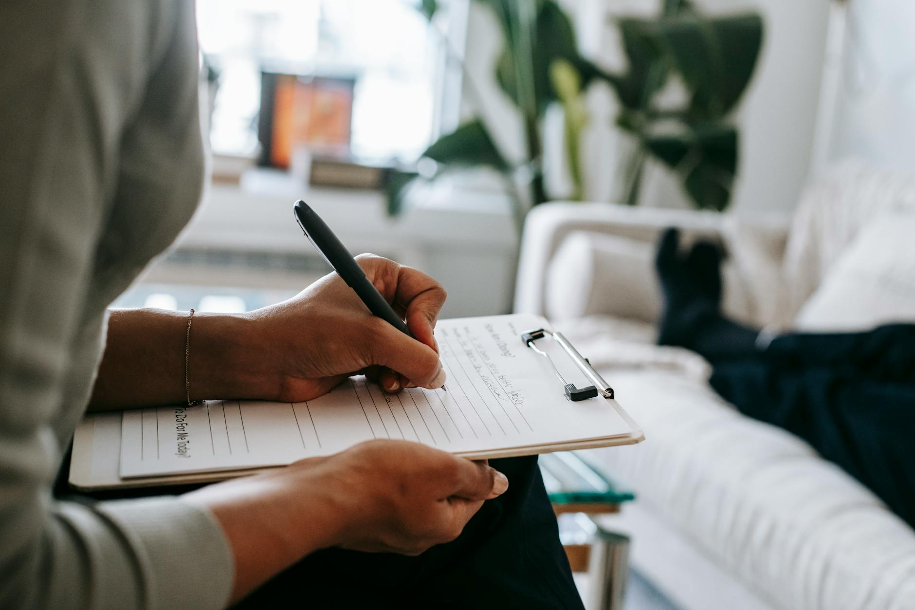 person filling out a health form with a pen