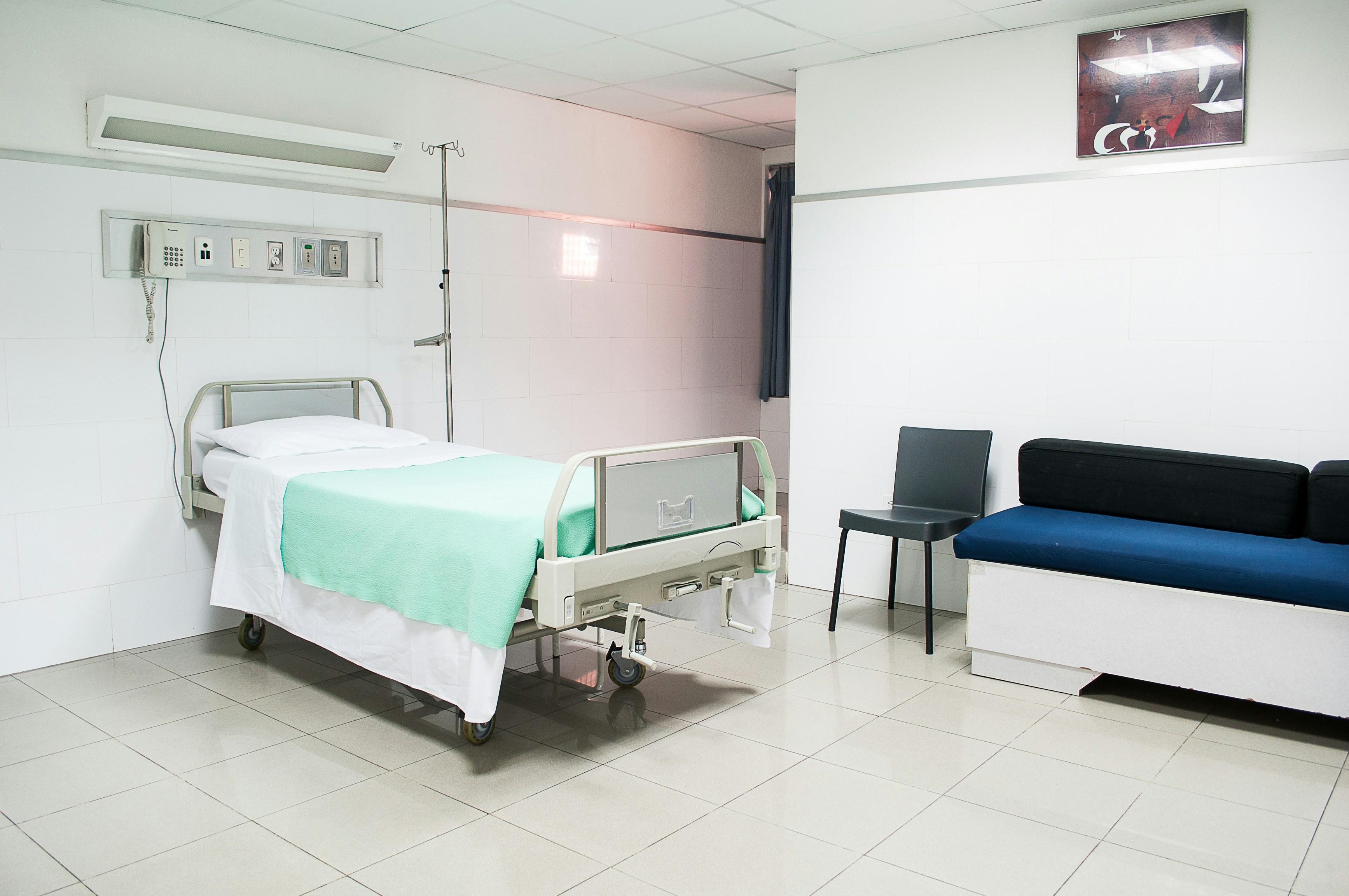 Empty hospital bed prepared for incoming patient